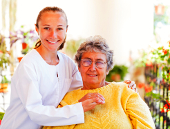 caregiver and elderly holding hands