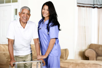 caregiver assisting her patient in walking